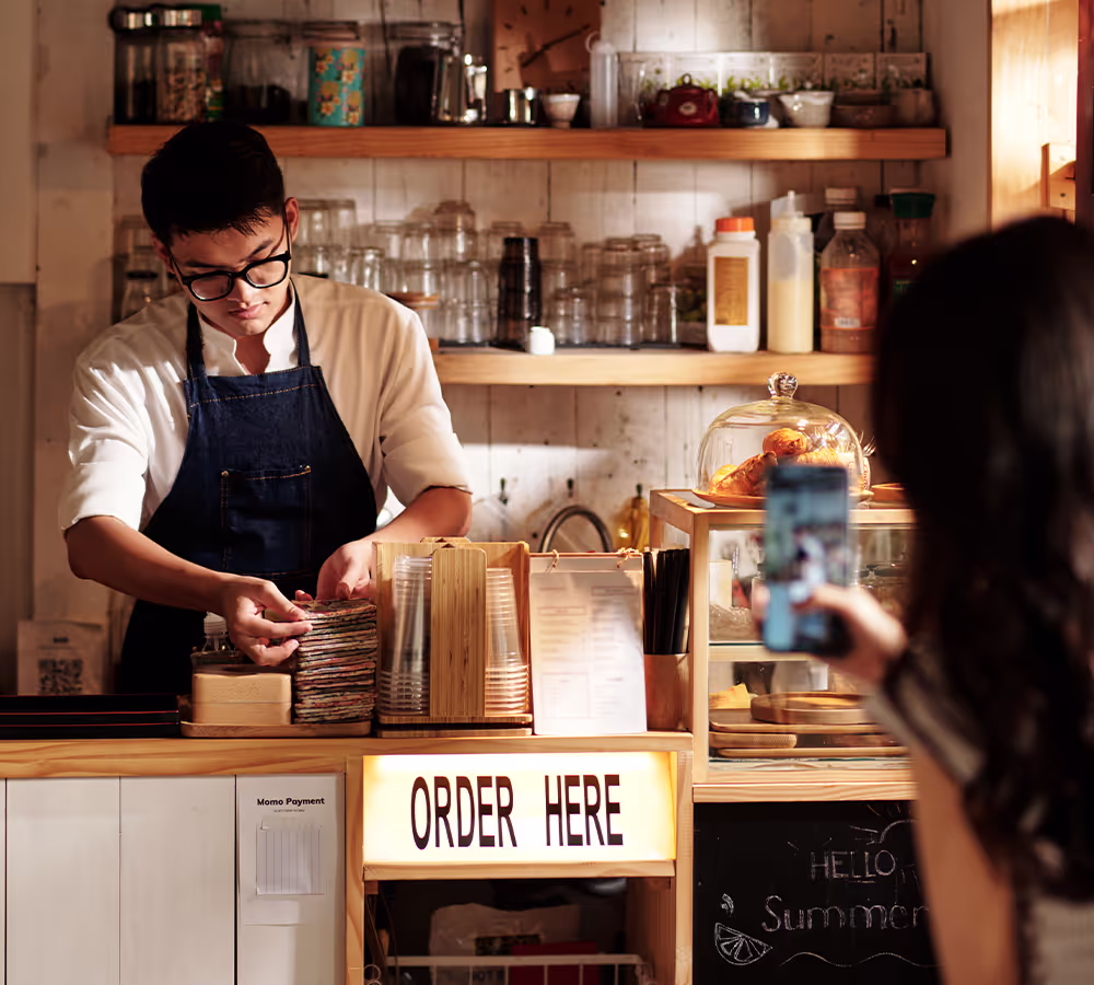 Barista preparing orders at a coffee counter