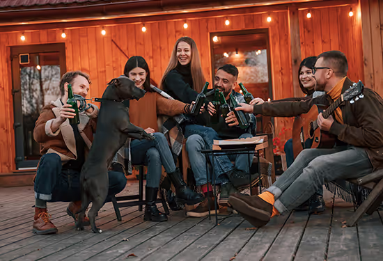 Group of friends relaxing with a dog outdoors